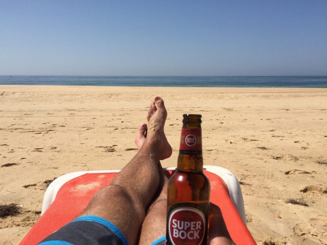 Portugal beach with beer in hand