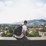 man with a small packable daypack for travel