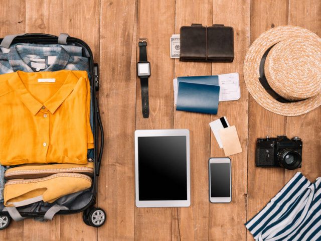 flat lay of solo trip travel items